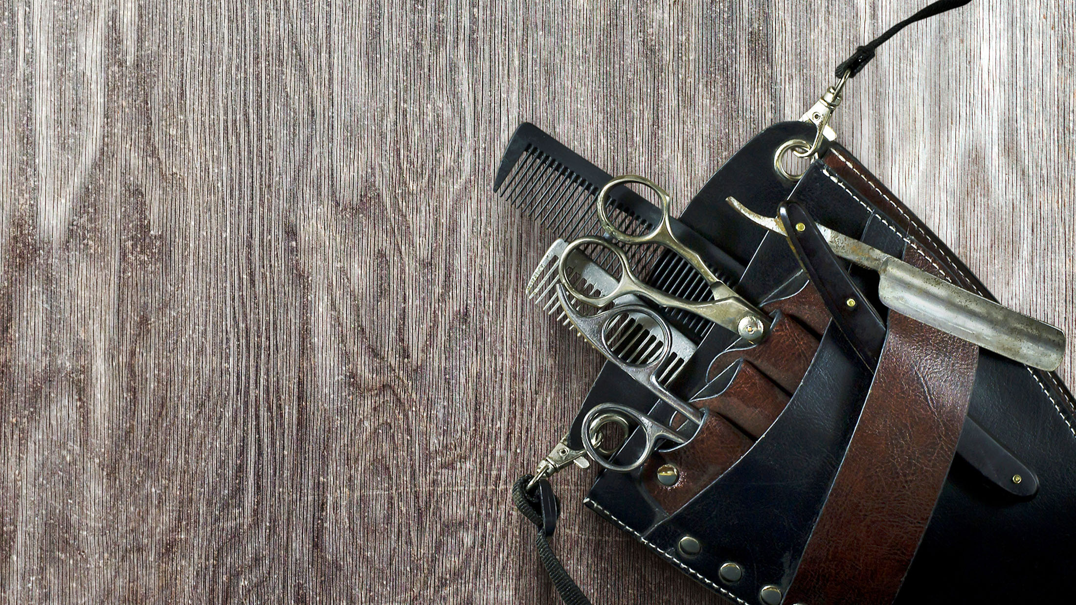 Professional barber tools on a wooden background representing Fwresh on demand service in Boston